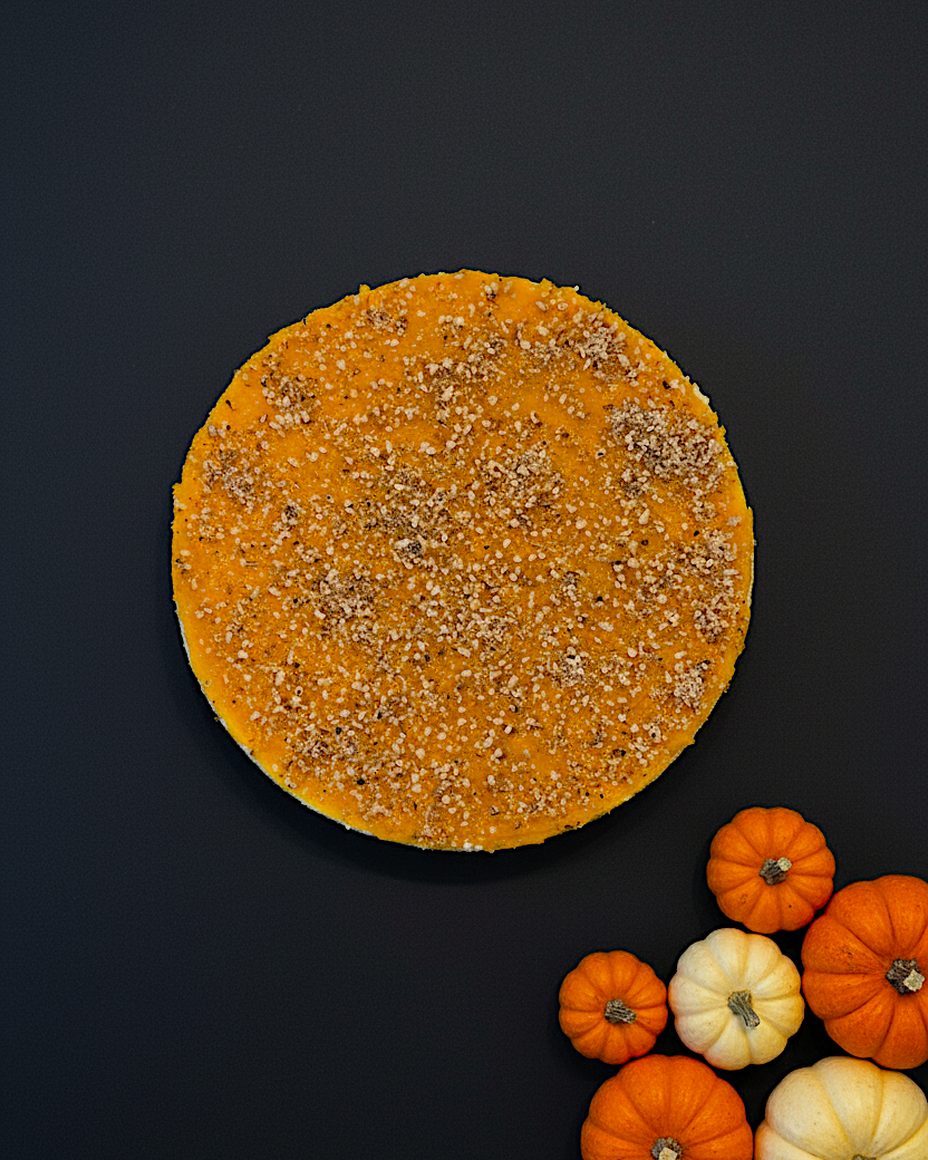 Cheesecake Pumpkin New York entier vu de dessus, avec de petits potirons à côté